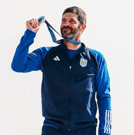Pavlos Kontides holding his Olympic silver medal